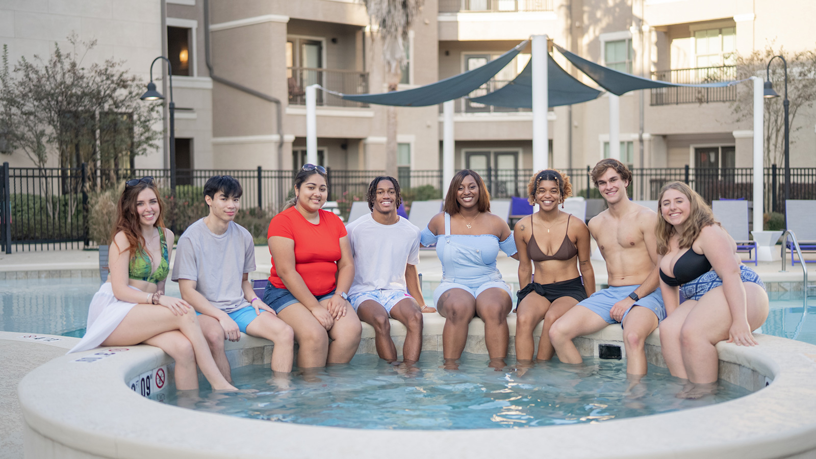 Group of young people with feet in hot tub